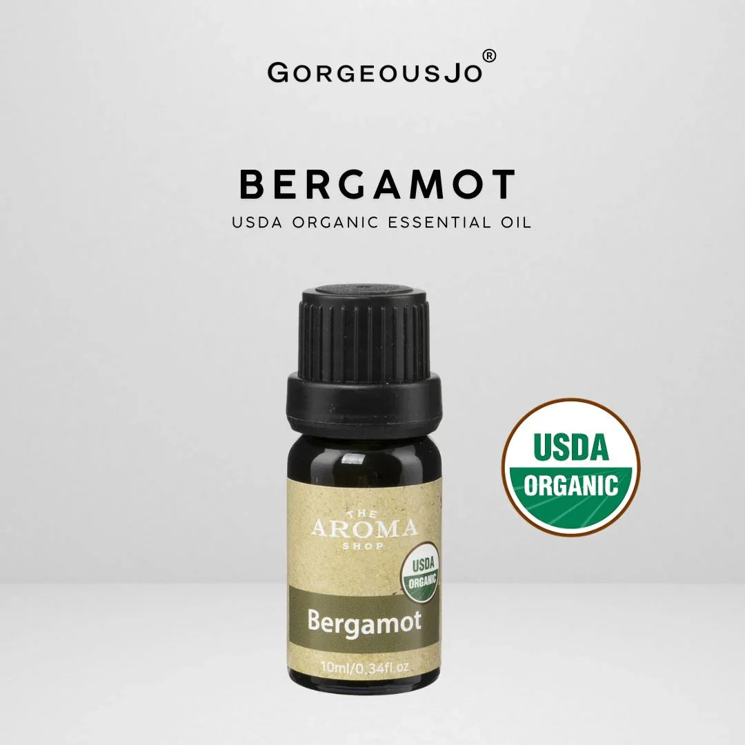 Bergamot essential oil bottle with USDA Organic label on a light gray background