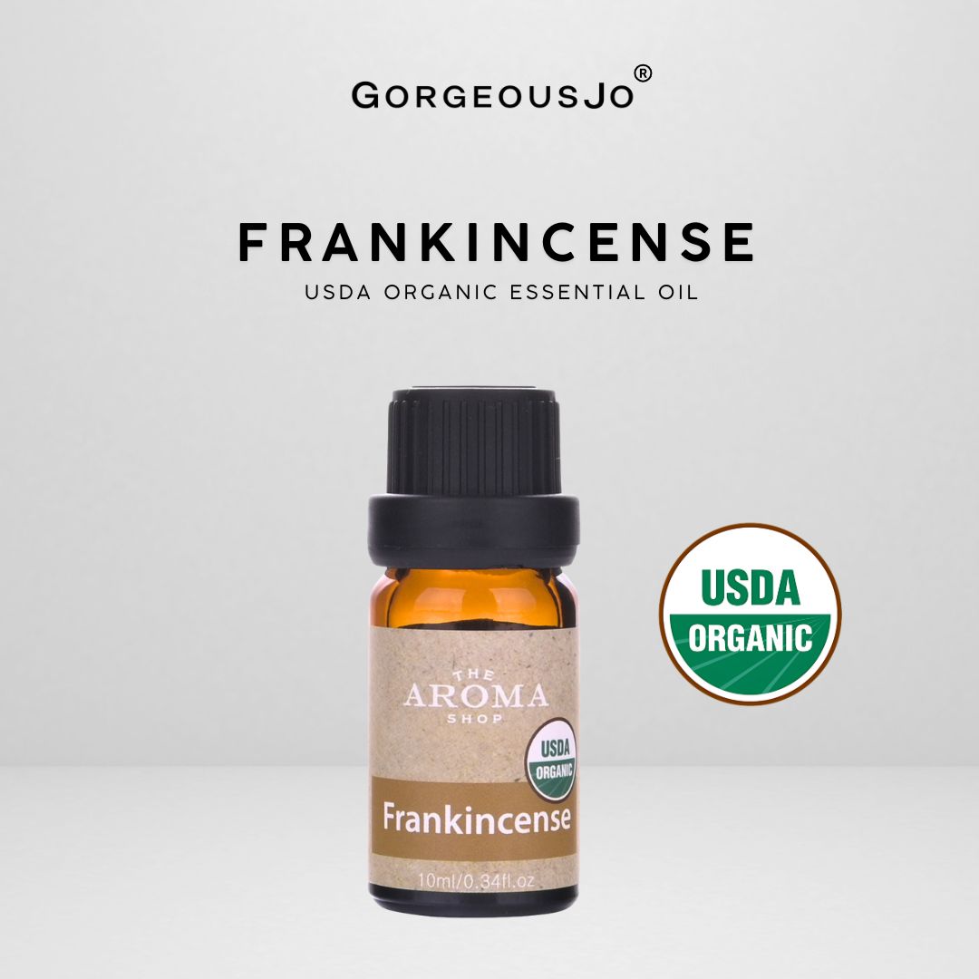 Frankincense essential oil bottle with USDA Organic label on a gray background