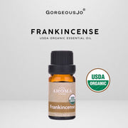 Frankincense essential oil bottle with USDA Organic label on a gray background