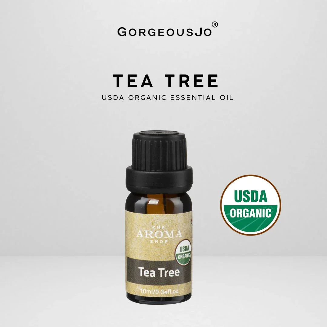 Tea tree essential oil bottle with USDA Organic label on a white background